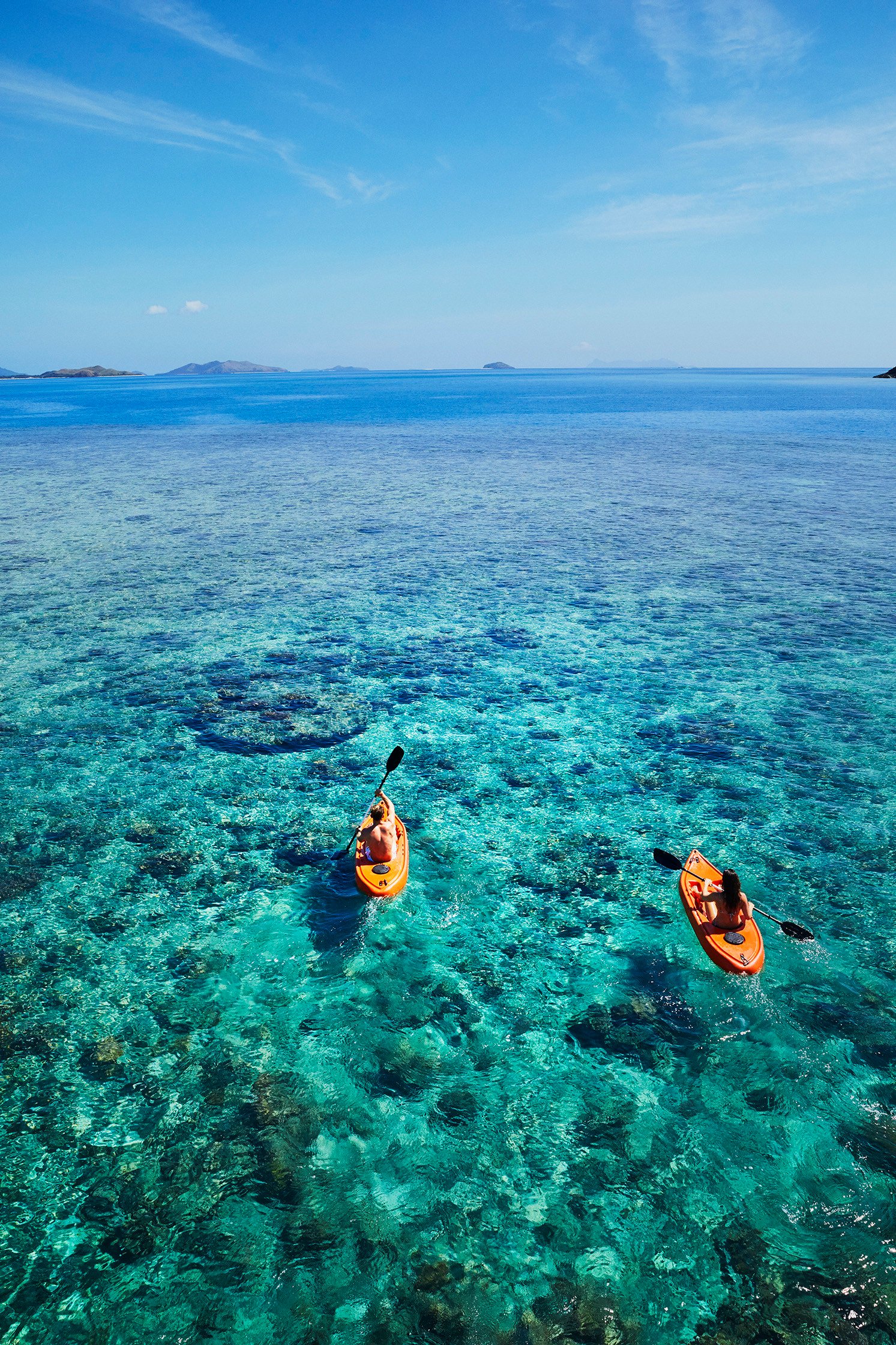 Couple paddling out to deeper water, photo: Tourism Fiji